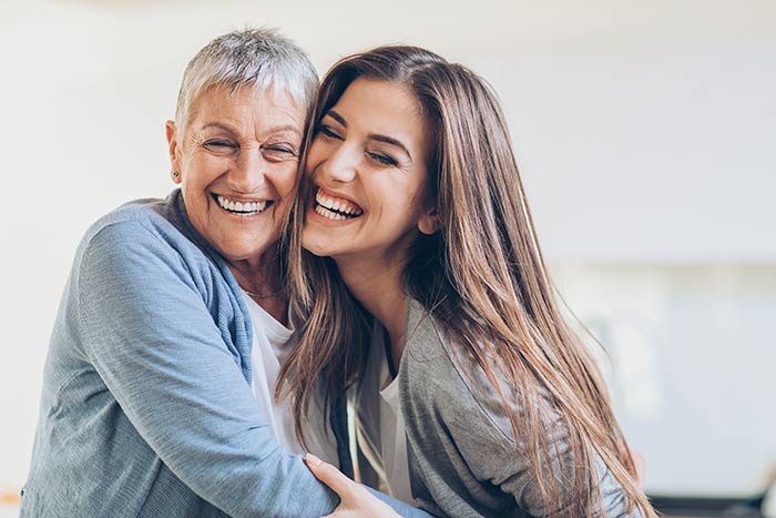 Mother and Daughter Smiling and Hugging