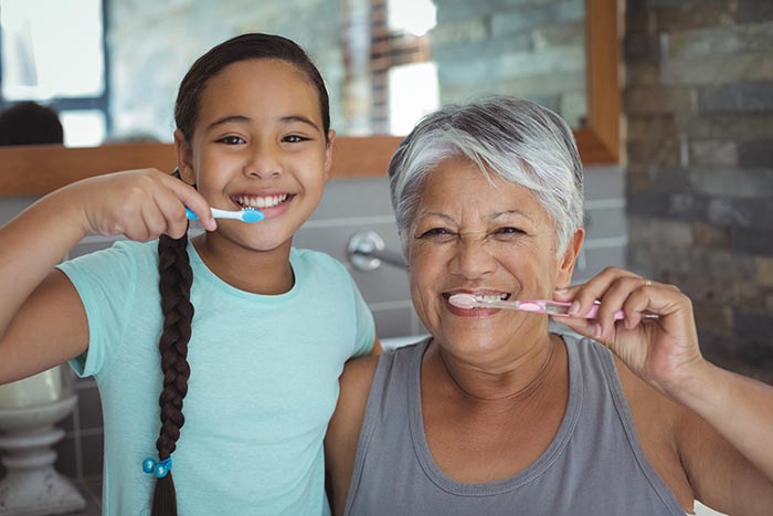 Grandmother and Child Brushing Teeth