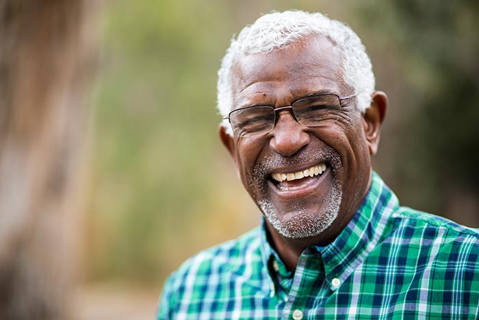 Elderly Man Laughing at Camera